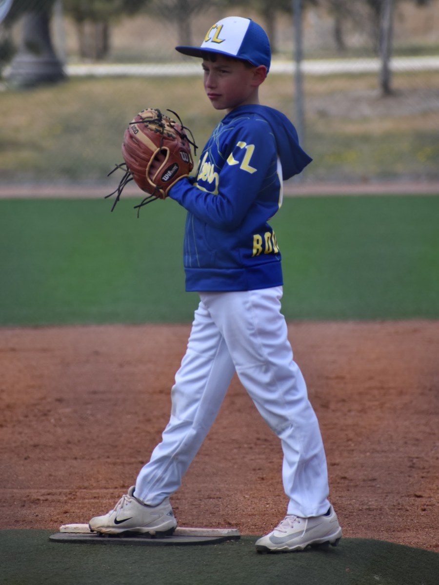 A Canyon Lakers pitcher coming set on the rubber
